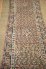 Perspective view of an antique Serab runner's allover trellis design and even, low-pile texture.