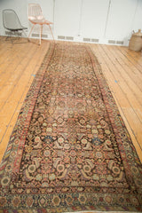 Vintage Malayer runner's low-pile Herati motif in blush, tangerine, and dark bronze brown.