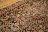 Herati motif on charcoal field with blush, orange, mauve, and barber pole border.