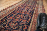 Vintage Malayer rug runner detail with rich navy field, vibrant red Herati motifs, and serrated patterns.