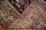 Malayer rug runner's underside revealing hand-knotted construction and varied thread colors.