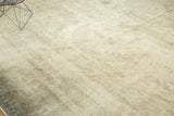 Distressed vintage Sparta carpet texture showing faded ivory, pale sage, and apricot floral tendrils.