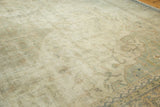 Vintage distressed Sparta carpet, exposed foundation, faded floral tendrils, pale sage green.