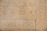 Worn pile texture and faded sky blue, pale bronze motifs on a distressed Sivas carpet.