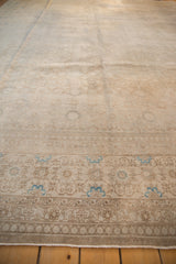 Distressed border detail with muted floral pattern and sky blue accents.