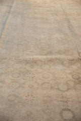 Distressed Sivas carpet close-up of worn pile, faded allover Veramin design, pale bronze and ivory.