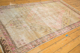 Distressed Khotan runner border featuring blush pink and chocolate brown, intricate patterns, and foundation wear.