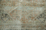 Distressed vintage Mahal carpet texture in faded terra cotta, pale sage, and charcoal hues.