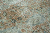 Close-up of distressed Mahal rug's even wear, muted terra cotta, sage, and silver colors.