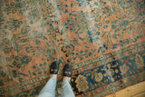 Antique distressed Lilihan carpet section with low pile blush and teal botanical design.