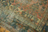 Distressed antique Lilihan carpet corner showcasing etched blush field and teal curvilinear border.
