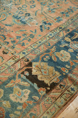 Distressed Persian Lilihan carpet, time-softened blush and teal potted plant motifs.