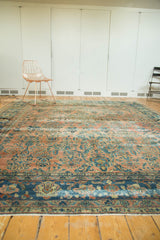 Distressed antique Lilihan carpet's lower border, showing teal, blush, and blue with foundation etching.