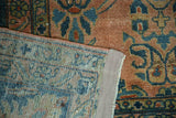 Lilihan carpet showing hand-knotted foundation and distressed floral pile with muted tones.