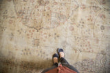 Vintage distressed Sparta rug with low pile and faded floral vinery, foundation showing through.