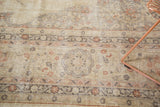 Worn floral motifs and muted beige, rose tones on a distressed Turkish Sparta carpet.
