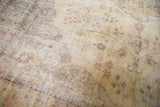 Distressed vintage Sparta rug showing even wear, faded ivory and pale rose floral designs.