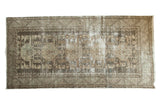 Distressed vintage Kula runner, central medallions, geometric florals, muted gray and beige tones.
