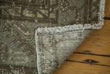 Distressed gray, beige, charcoal vintage Kula rug pile, showing fringe and hand-knotted back.