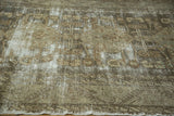 Faded texture and muted charcoal, silver, and beige tones of a distressed Kula rug.