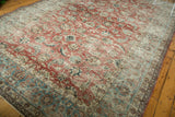 Distressed vintage Persian Kashan rug corner, showing worn cherry red palmette field and faded aqua blue border.