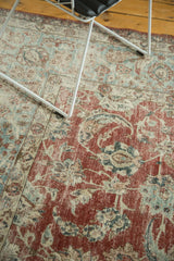 Distressed vintage Kashan rug, cherry red field with faded blue palmette motifs.