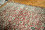 Distressed vintage Kashan rug with cherry red field, blue floral, and sickle leaf patterns.
