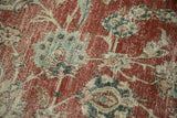 Distressed vintage Kashan carpet showing worn cherry red field with ornate blue palmettes and floral motifs.