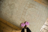 Distressed vintage Oushak runner with faded geometric medallion pattern in beige and ivory tones.