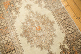 Distressed Oushak rug: worn ivory field, pale bronze rectilinear motifs, tangerine accents.
