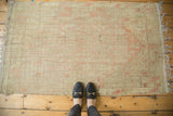 Distressed vintage Tulu rug showing low pile, visible foundation, and faded blush with beige tones.