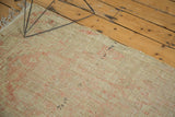 Distressed Tulu rug detail with low pile, visible foundation, and blush patterns.