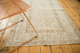 Distressed Oushak rug with allover cintimani-like field and pale neutral tones.