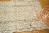 Distressed pale beige and silver cintimani pattern and border of a vintage Oushak rug.