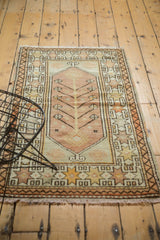 Blush tree of life with geometric vinery and starburst border on vintage Oushak rug.