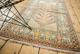 Ivory fringe, peach starburst, and meandering vine borders on a vintage Oushak rug.