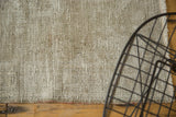 Close-up of the vintage distressed Oushak rug's texture, revealing beige and ivory foundation.