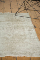 Vintage distressed Oushak rug's textured surface, revealing mostly foundation and analogous beige tones.