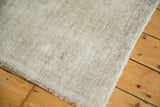 Hand-knotted foundation texture and secured edges of the distressed Oushak rug.