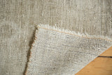 Distressed Oushak rug's hand-knotted foundation and worn beige pile with short fringe.