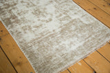 Hard distress with foundation showing and blanket stitched edge of vintage Oushak rug.