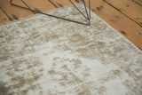 Decorative distressed texture on vintage Oushak rug, revealing ivory foundation and blanket-stitched edge.