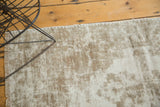 Distressed ivory and beige vintage Oushak rug, showing foundation and blanket-stitched edge.