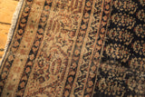 Distressed Sparta carpet with heavy abrash, worn pile, and patterns in navy, bronze, red.