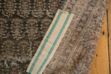 Beige burlap with teal stripes affixed to the reverse of the distressed Sparta carpet.