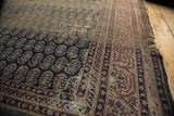 Distressed Sparta carpet corner reveals heavy wear, abrashed pile, and rich patterned borders.