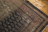 Distressed vintage Sparta rug corner displaying navy botehs, heavy abrash, and isolated wear.