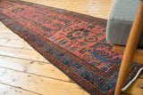 Hand-knotted vintage Lilihan runner with blossomed red and indigo floral motifs.