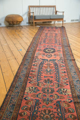 Vintage Lilihan rug runner with blossomed floral bouquets, indigo blue, madder red, and even wear.