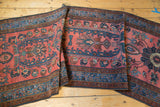 Hand-knotted Lilihan runner with madder red field, sprawling floral motifs, and blue border.